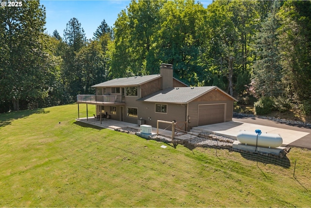 37333 NE Reed Rd, Corbett, OR 97019 - rear view of property featuring a chimney, a yard, driveway, a deck, and an attached garage
