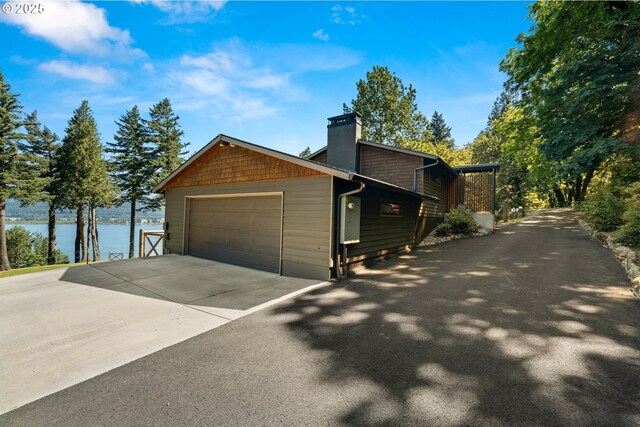37333 NE Reed Rd, Corbett, OR 97019 - view of side of home featuring a water view, a chimney, a garage, and driveway