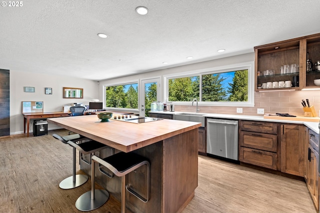 37333 NE Reed Rd, Corbett, OR 97019 - kitchen featuring dishwasher, butcher block countertops, light wood-type flooring, a breakfast bar area, and a textured ceiling