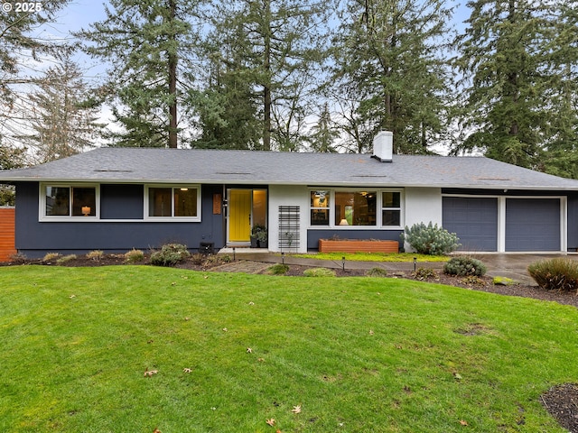 ranch-style home with a garage and a front lawn