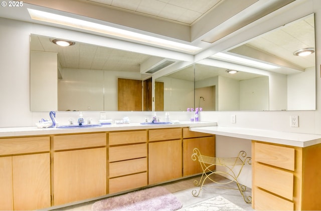 full bathroom with a sink and double vanity