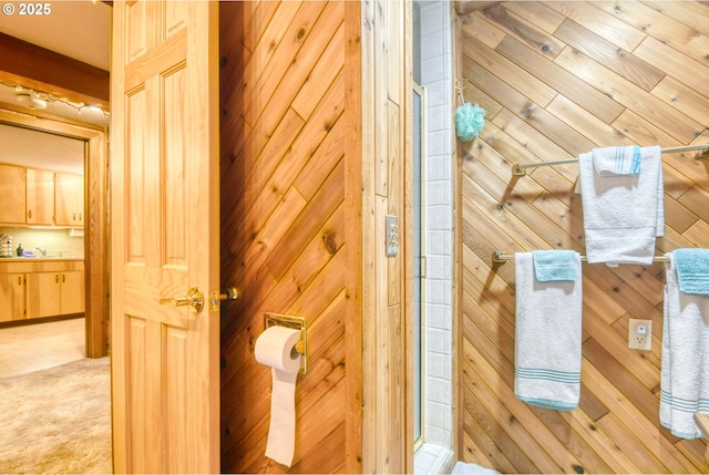 interior space featuring walk in shower and wood walls