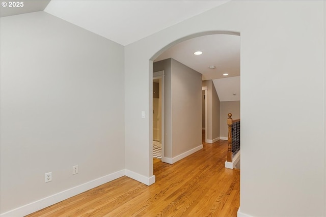10235 NW Edgewood Dr Unit 25, Portland, OR 97229 - hallway with light wood finished floors, an upstairs landing, recessed lighting, arched walkways, and lofted ceiling