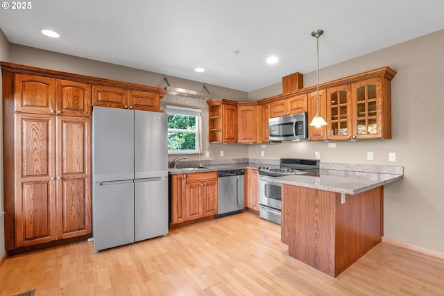 425 SE Shell Ave Unit 4, Depoe Bay, OR 97341 - kitchen featuring stainless steel appliances, a peninsula, glass insert cabinets, open shelves, and brown cabinetry