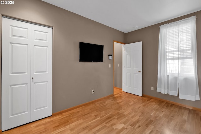 425 SE Shell Ave Unit 4, Depoe Bay, OR 97341 - unfurnished bedroom featuring light wood-type flooring, baseboards, and a closet