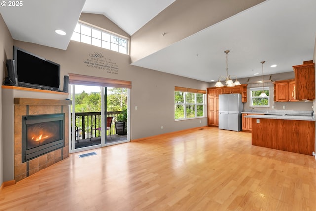 425 SE Shell Ave Unit 4, Depoe Bay, OR 97341 - unfurnished living room with a tile fireplace, plenty of natural light, light wood-type flooring, recessed lighting, and baseboards
