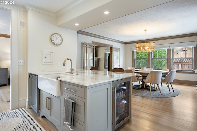 kitchen featuring wine cooler, pendant lighting, gray cabinets, light stone countertops, and dishwasher