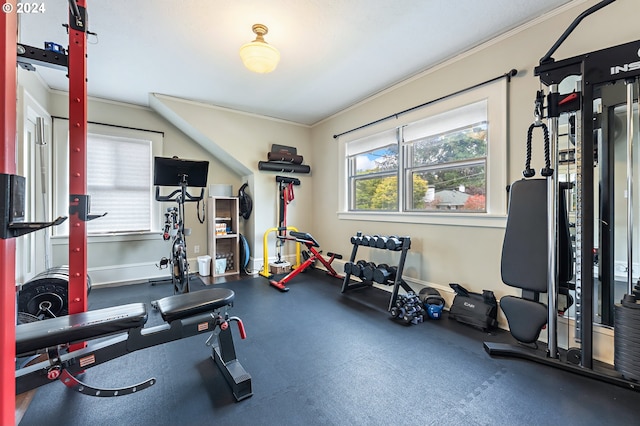 exercise room featuring ornamental molding and baseboards