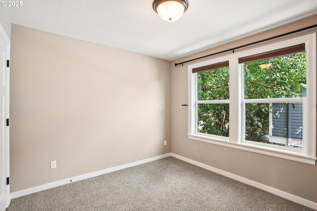 665 NE Skidmore St, Portland, OR 97211 - spare room featuring carpet floors and baseboards