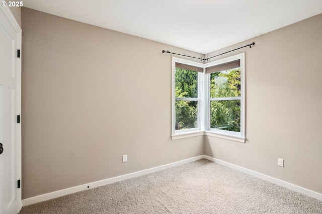 665 NE Skidmore St, Portland, OR 97211 - carpeted empty room featuring baseboards