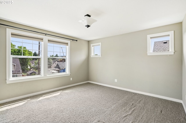 665 NE Skidmore St, Portland, OR 97211 - carpeted spare room featuring baseboards