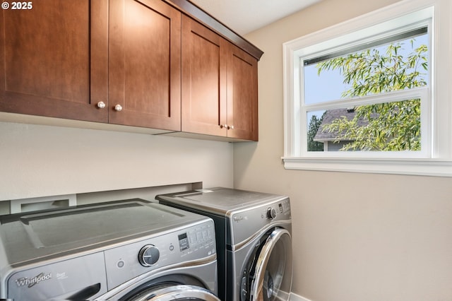 665 NE Skidmore St, Portland, OR 97211 - laundry room featuring separate washer and dryer and cabinet space