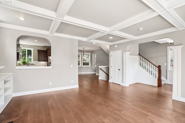 665 NE Skidmore St, Portland, OR 97211 - unfurnished living room featuring coffered ceiling, plenty of natural light, wood finished floors, beam ceiling, and recessed lighting