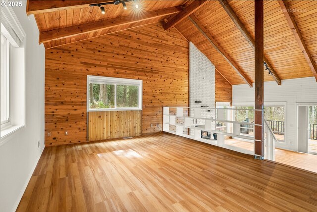 20740 S Shelley Ln, Beavercreek, OR 97004 - unfurnished living room featuring a wooden ceiling with exposed beams, wood walls, wood finished floors, high vaulted ceiling, and rail lighting