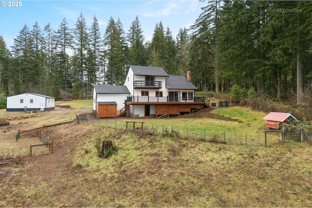 20740 S Shelley Ln, Beavercreek, OR 97004 - back of property featuring a deck, a chimney, a view of trees, stairs, and an outbuilding