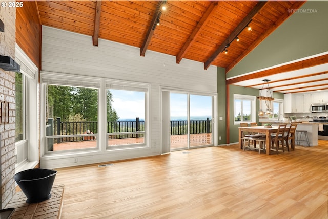 20740 S Shelley Ln, Beavercreek, OR 97004 - living room featuring rail lighting, high vaulted ceiling, a wood ceiling with exposed beams, and light wood-style flooring