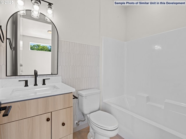 1612 SE Morrison St Unit 2, Portland, OR 97214 - bathroom with vanity, toilet, bathing tub / shower combination, and tile walls