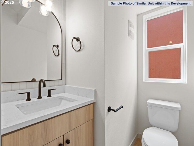 1612 SE Morrison St Unit 2, Portland, OR 97214 - half bath featuring toilet, vanity, and baseboards