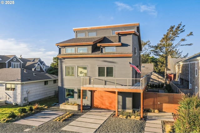 view of front of home with a balcony and fence