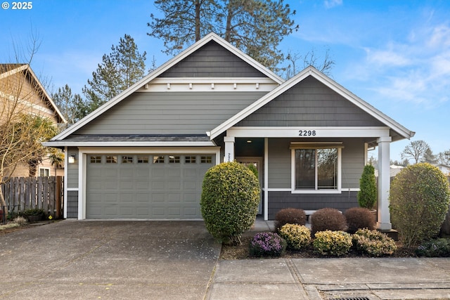 view of front of house with fence, a garage, and driveway