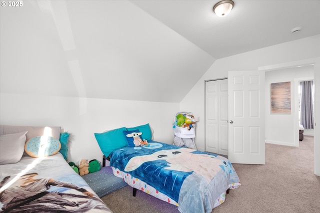 carpeted bedroom featuring vaulted ceiling and a closet