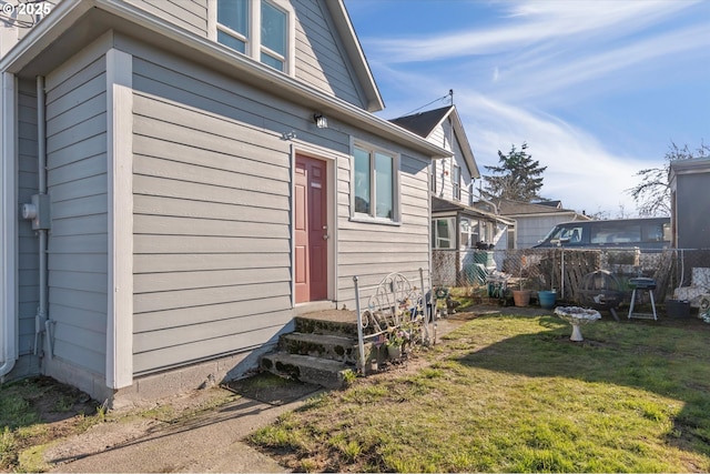 view of side of home featuring a lawn