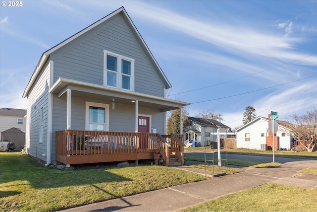 bungalow-style house with a front yard and covered porch