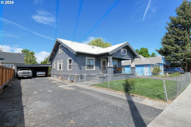 view of front facade with a front lawn and a carport