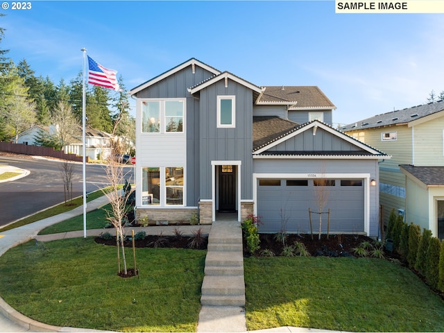 craftsman inspired home featuring a garage and a front yard