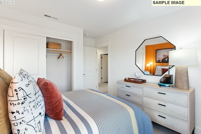 carpeted bedroom featuring a closet and visible vents