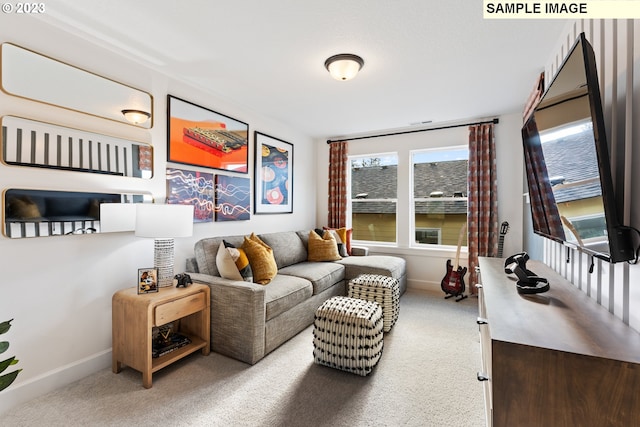 sitting room featuring carpet and baseboards