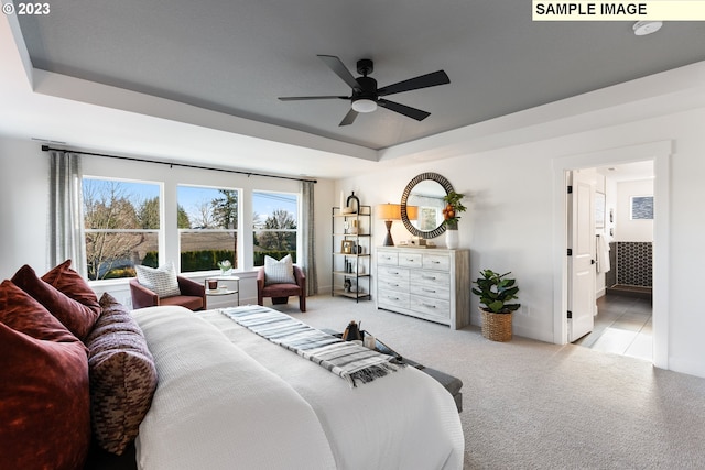 bedroom featuring baseboards, a raised ceiling, and light colored carpet