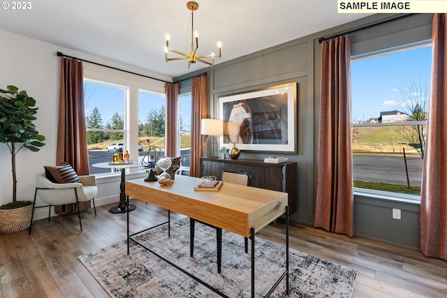 office area with hardwood / wood-style flooring and a notable chandelier