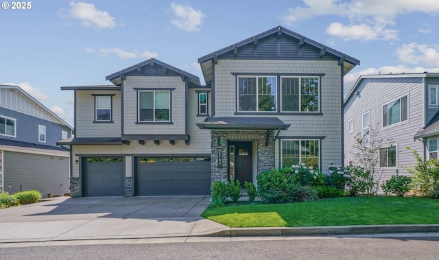 craftsman-style home with a front yard, concrete driveway, stone siding, and an attached garage