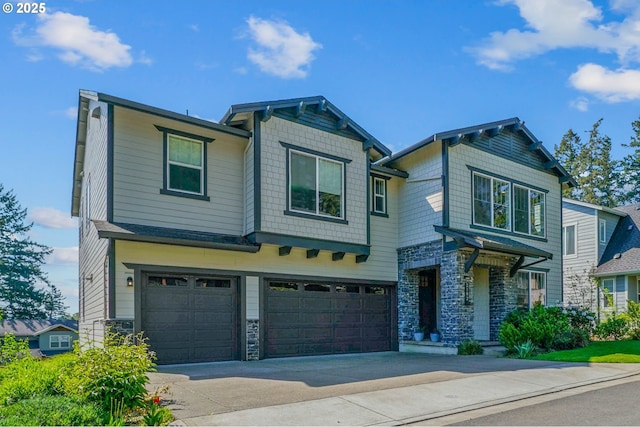 craftsman inspired home featuring concrete driveway, stone siding, and a garage