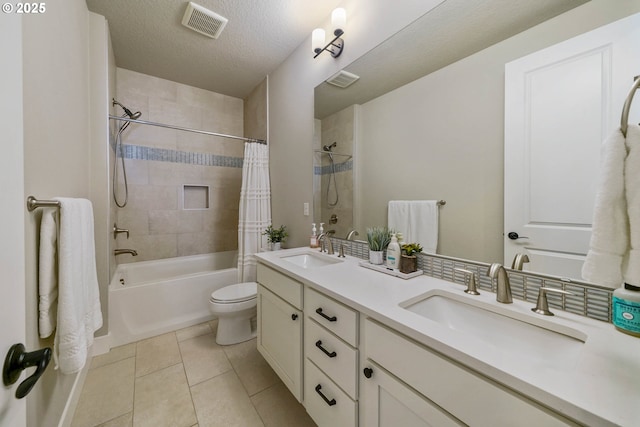 bathroom featuring shower / tub combo with curtain, visible vents, toilet, and a sink