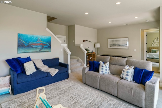 carpeted living area with stairway and recessed lighting