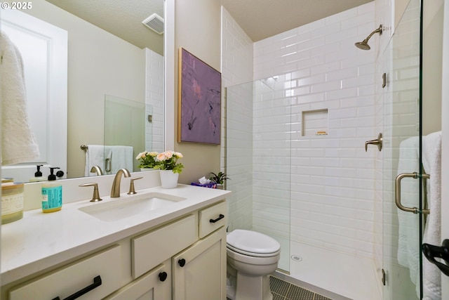 full bath featuring toilet, tile patterned floors, a shower stall, and vanity