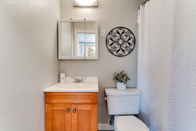 bathroom with toilet and vanity