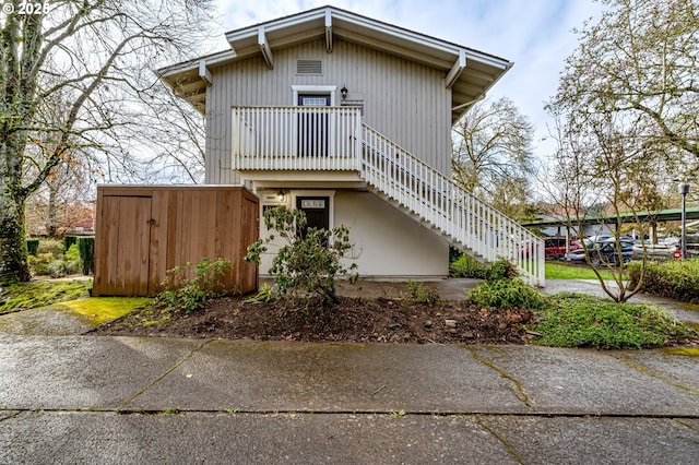 view of front of property featuring stairs