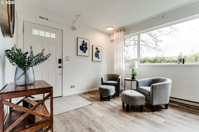 entryway with baseboards and light wood finished floors