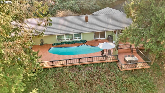 view of swimming pool with a deck