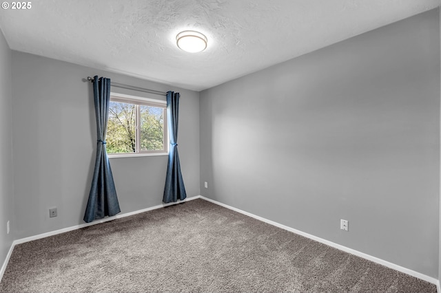 unfurnished room featuring a textured ceiling, baseboards, and carpet flooring