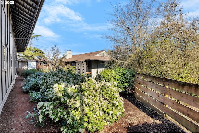 view of yard with a vegetable garden and fence