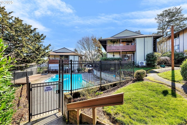 pool featuring a yard and fence