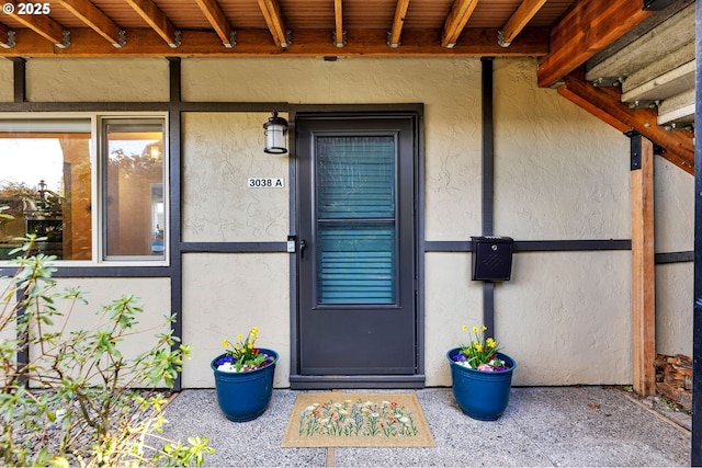 property entrance with stucco siding