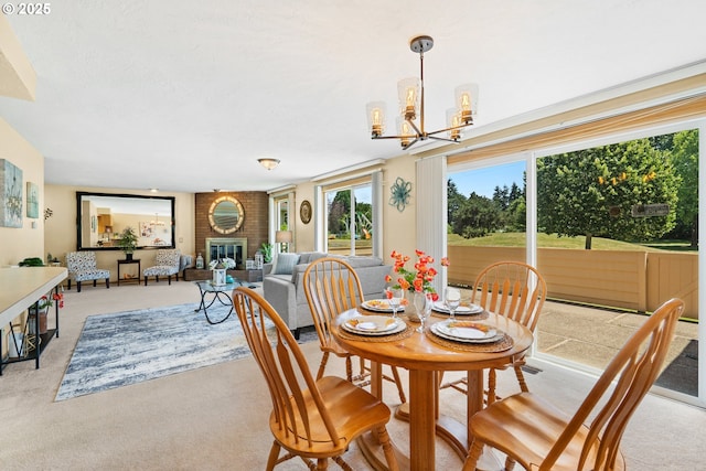 2935 Cedarwood Ct, Albany, OR 97322 - dining room with a chandelier, light colored carpet, and a fireplace