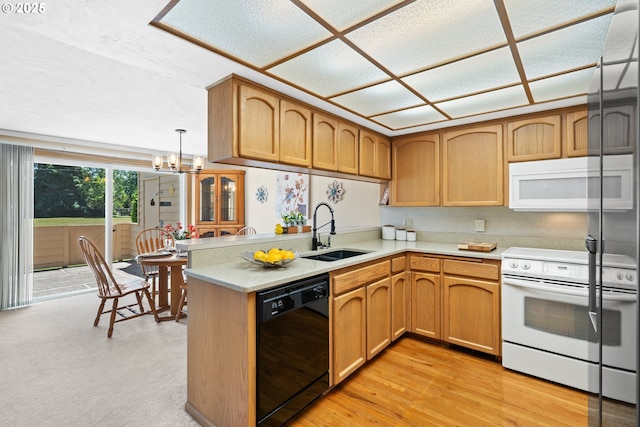 2935 Cedarwood Ct, Albany, OR 97322 - kitchen featuring white appliances, light countertops, a chandelier, a peninsula, and light wood-type flooring