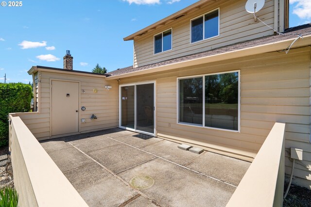 2935 Cedarwood Ct, Albany, OR 97322 - rear view of house with a chimney, a patio, and a shingled roof
