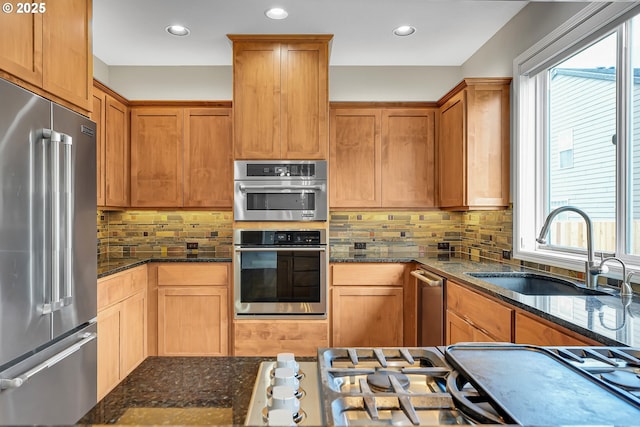 16099 SE Venice Ridge Way, Damascus, OR 97089 - kitchen featuring stainless steel appliances, healthy amount of natural light, tasteful backsplash, dark stone countertops, and recessed lighting